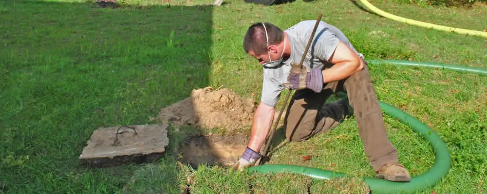 Septic pumping technician servicing a residential septic tank in Hoboken, NJ